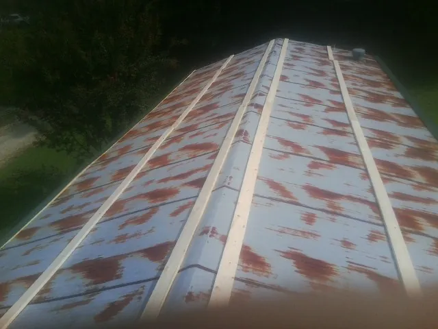 Rusted metal roof panels with new wood purlins before replacement — Storm Damage Roof Repair in Leesport by Roofing Brothers
